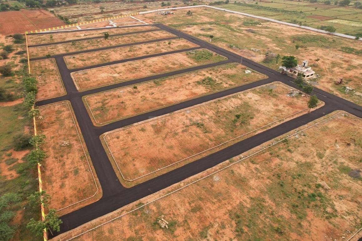 Aerial view of open residential plots with paved roads, offered by real estate companies in Hyderabad